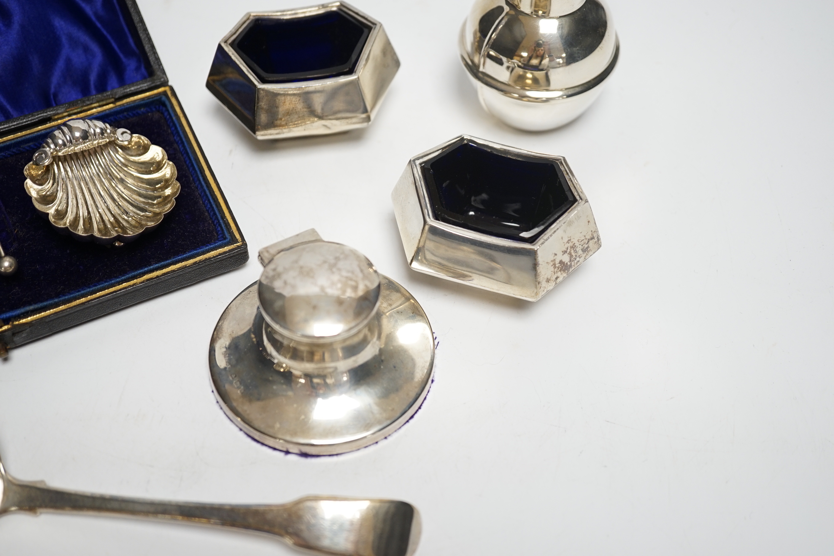 A cased pair of silver salts, one other pair of salts, a Guernsey miniature silver milk jug, an inkwell and two silver sifter ladles.